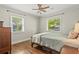 Bedroom featuring hardwood floors, two windows providing ample natural light, and a ceiling fan for added comfort at 1211 Eastwood Ave, Hanahan, SC 29410