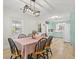 Elegant dining area with contemporary chandelier and a view into a bright, vintage-inspired kitchen at 1211 Eastwood Ave, Hanahan, SC 29410