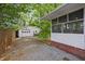 Rear view featuring detached garage and sunroom in the backyard at 1211 Eastwood Ave, Hanahan, SC 29410