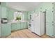 Bright kitchen with fresh green cabinetry, updated appliances, and large window overlooking the backyard at 1211 Eastwood Ave, Hanahan, SC 29410