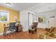Inviting living space features hardwood floors, dedicated desk space, and lots of natural light at 1211 Eastwood Ave, Hanahan, SC 29410