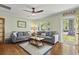 Inviting living room with hardwood floors, gray sofas, neutral walls, and natural light from the window at 1211 Eastwood Ave, Hanahan, SC 29410