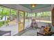 Bright, airy sunroom featuring large windows, comfortable seating, and views of the private backyard at 1211 Eastwood Ave, Hanahan, SC 29410