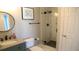 Bathroom with granite counters, a wood-trimmed mirror, a large shower, and tiled floors at 126 Jungle Rd # 7B, Edisto Beach, SC 29438