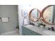 Bathroom featuring granite counters, double sinks, wood-trimmed mirrors, and coastal decor at 126 Jungle Rd # 7B, Edisto Beach, SC 29438