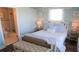 Bedroom featuring a white rattan bed, coastal decor, and an en suite bathroom at 126 Jungle Rd # 7B, Edisto Beach, SC 29438