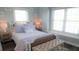Bright bedroom with a rattan-trimmed bed, a plush bench, and ample natural light at 126 Jungle Rd # 7B, Edisto Beach, SC 29438