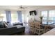 Bright living room with modern furnishings, hardwood floors, and sliding glass doors at 126 Jungle Rd # 7B, Edisto Beach, SC 29438