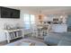 Stylish living room with a dining table and a view into the well-equipped kitchen at 126 Jungle Rd # 7B, Edisto Beach, SC 29438