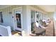 Charming porch with cozy seating, lanterns, and a decorated front door adding to the curb appeal at 126 Jungle Rd # 7B, Edisto Beach, SC 29438
