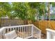 Landscaped backyard with deck, patio, lush greenery, and privacy fencing at 13 H St, Charleston, SC 29403