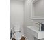 Modern half bathroom features a stylish sink, sleek fixtures, and a toilet with wood floors at 13 H St, Charleston, SC 29403