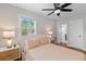 Bright bedroom with wood floors, ceiling fan, two bedside tables, and closet access at 13 H St, Charleston, SC 29403