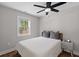 A bright bedroom with a window and ceiling fan features wood floors and a modern bed at 13 H St, Charleston, SC 29403