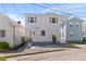 Charming two-story home with white siding, updated windows, and a well-manicured landscape at 13 H St, Charleston, SC 29403