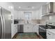 Well-equipped kitchen with stainless steel appliances, white cabinets, and updated fixtures at 13 H St, Charleston, SC 29403