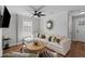 Comfortable living room with modern decor, a ceiling fan, and ample natural light at 13 H St, Charleston, SC 29403