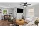 Stylish living area featuring a modern sofa, ceiling fan, and entertainment center at 13 H St, Charleston, SC 29403
