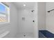 Modern shower with white subway tile, contrasting dark fixtures, and mosaic shower floor at 13 H St, Charleston, SC 29403