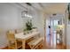 Bright dining room with modern table, bench, stylish lighting, and a view into the hall at 1307 Ventura Pl, Mount Pleasant, SC 29464