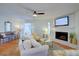 Cozy living room with fireplace, ceiling fan, white sofa and cheerful decor at 1307 Ventura Pl, Mount Pleasant, SC 29464