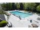 Community pool area with lounge chairs and tables, surrounded by lush greenery at 1307 Ventura Pl, Mount Pleasant, SC 29464