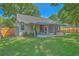 Spacious backyard with a wooden fence, lush grass, and a screened-in porch, ideal for outdoor living at 1315 Old Mill Ln, Mount Pleasant, SC 29464