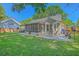 Private backyard features a screened-in porch and a charming patio area, perfect for outdoor entertaining at 1315 Old Mill Ln, Mount Pleasant, SC 29464