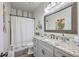 Well-lit bathroom showcasing a granite countertop vanity, gray cabinets, and a shower with curtain at 1315 Old Mill Ln, Mount Pleasant, SC 29464
