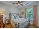 Cozy bedroom features a decorative iron bed frame, bright natural light, and hardwood floors at 1315 Old Mill Ln, Mount Pleasant, SC 29464