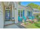 Charming front porch with cozy blue chairs, a welcoming entrance, and well-maintained landscaping at 1315 Old Mill Ln, Mount Pleasant, SC 29464
