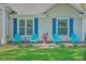 Charming front porch with cozy blue chairs, perfect for relaxing and enjoying the neighborhood views at 1315 Old Mill Ln, Mount Pleasant, SC 29464