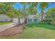 Charming single-story home with a well-manicured lawn, blue shutters, and inviting front porch seating at 1315 Old Mill Ln, Mount Pleasant, SC 29464