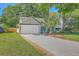 Inviting single-story home with a spacious driveway, beautiful lawn, and a charming, covered front porch at 1315 Old Mill Ln, Mount Pleasant, SC 29464