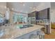 An open kitchen with marble countertops, stainless steel appliances, and custom cabinetry at 1315 Old Mill Ln, Mount Pleasant, SC 29464