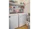 Functional laundry room featuring a side-by-side washer and dryer, plus ample shelving space for storage at 1315 Old Mill Ln, Mount Pleasant, SC 29464
