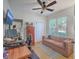 Bright office space with a ceiling fan, comfortable sofa, and a functional work area at 1315 Old Mill Ln, Mount Pleasant, SC 29464