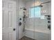 Large walk-in shower boasts white marble tiling, dual shower heads and window providing natural light at 1315 Old Mill Ln, Mount Pleasant, SC 29464