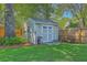 Backyard features a quaint storage shed, bench, and manicured lawn, offering both functionality and charm at 1315 Old Mill Ln, Mount Pleasant, SC 29464