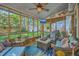 Inviting sunroom with comfortable wicker furniture, fan, screened windows, and view of the backyard at 1315 Old Mill Ln, Mount Pleasant, SC 29464