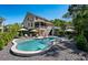 Backyard oasis with a freeform pool, lounge area, and lush landscaping, perfect for outdoor relaxation and entertaining at 1339 River Otter Court, Mount Pleasant, SC 29466