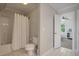 Bright bathroom featuring a shower-tub combo with white tile floors and neutral wall color at 1339 River Otter Court, Mount Pleasant, SC 29466