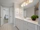 Bathroom with a white vanity, large mirror, and neutral tile flooring at 1339 River Otter Court, Mount Pleasant, SC 29466