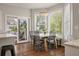 Sunlit dining area with hardwood floors, chandelier, and large windows providing views of the beautifully landscaped yard at 1339 River Otter Court, Mount Pleasant, SC 29466
