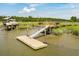 Waterfront dock with a covered pier head and boat ready for a day out on the water at 1339 River Otter Court, Mount Pleasant, SC 29466