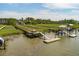 Waterfront property featuring expansive docks with a covered pier head and boat lift for convenient water access at 1339 River Otter Court, Mount Pleasant, SC 29466