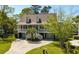 Two-story home with a welcoming front porch, a yard, and a driveway at 1339 River Otter Court, Mount Pleasant, SC 29466