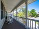 Inviting front porch with rocking chairs and views of the surrounding neighborhood at 1339 River Otter Court, Mount Pleasant, SC 29466