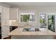 Bright kitchen features granite counters, stainless appliances, and a view to the outdoor patio at 1339 River Otter Court, Mount Pleasant, SC 29466