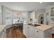 Bright kitchen with white cabinets, granite countertops, and an eat-in breakfast area at 1339 River Otter Court, Mount Pleasant, SC 29466